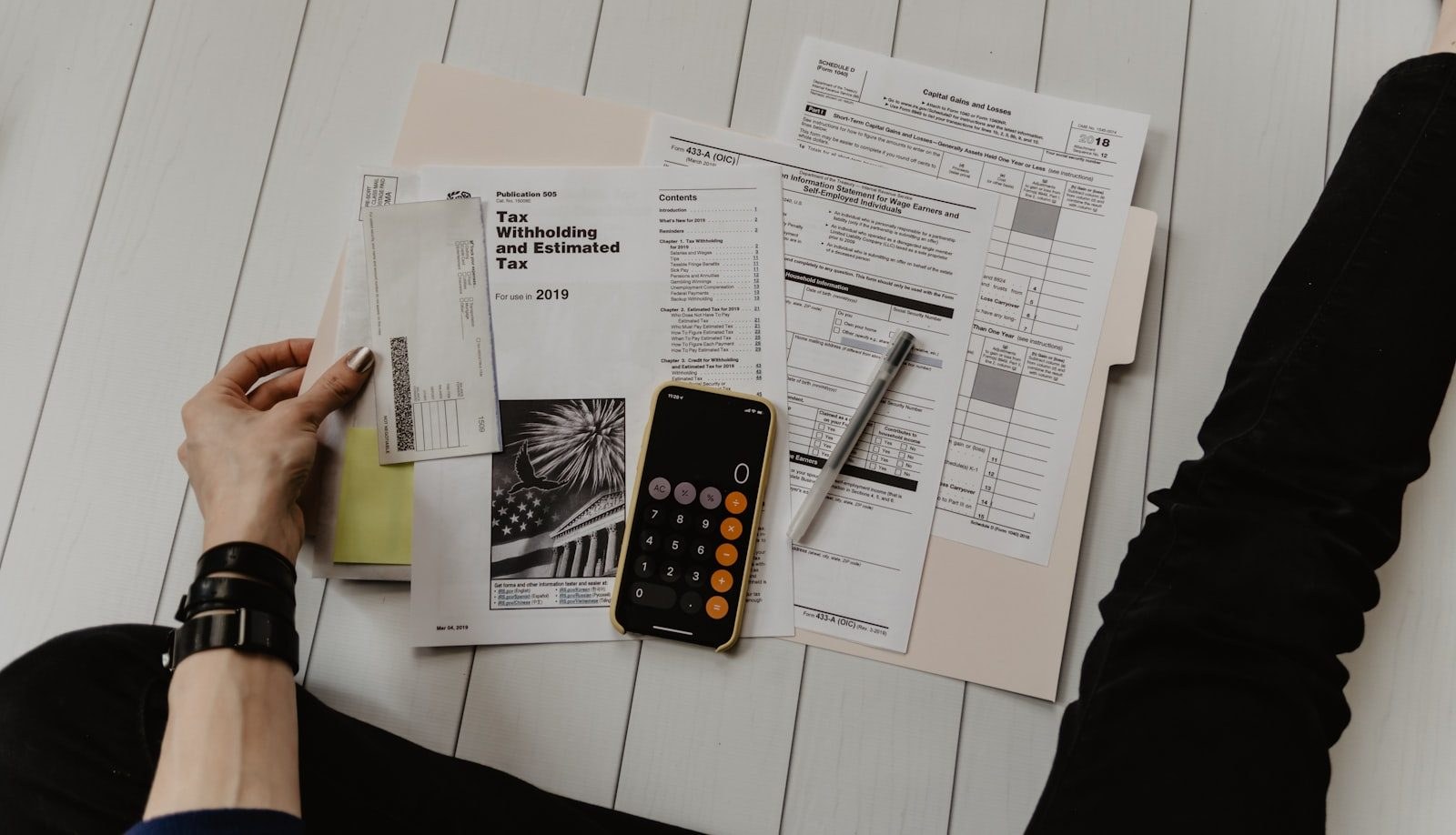 Papers, a calculator and a pen on a working desk